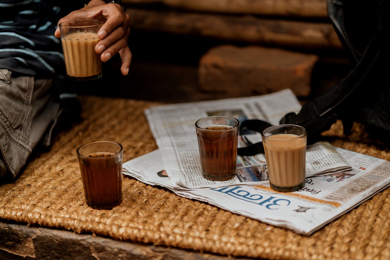 A cozy tea setup with glasses of Nepali milk tea on a woven rug, capturing traditional vibes.